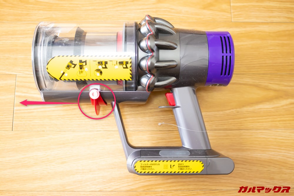 Dyson Cyclone V10 Fluffy SV12 FFの本体ダストカップの下部にある赤いレバーを前方にスライドさせます。
